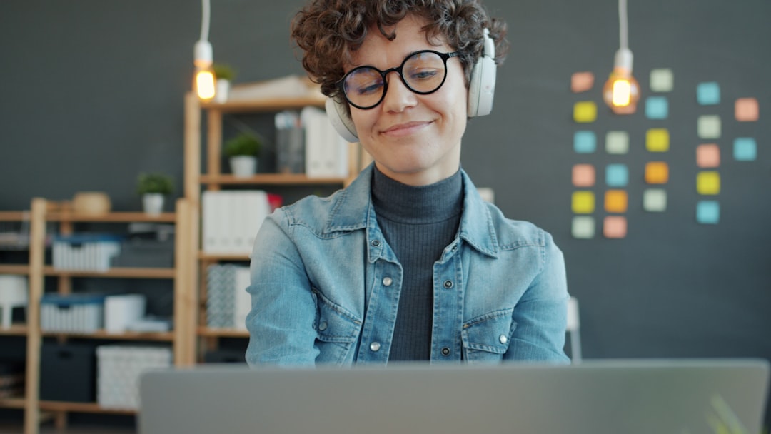 Woman using laptop with headphones